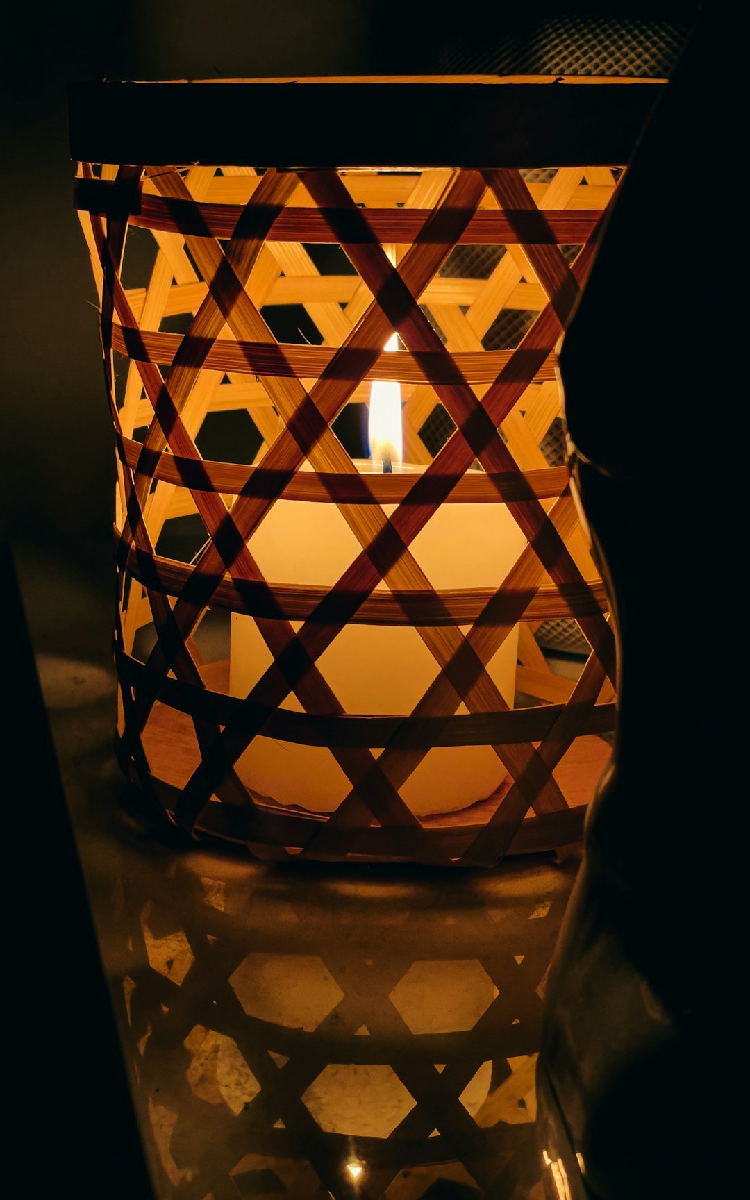 a lit candle sitting on top of a table