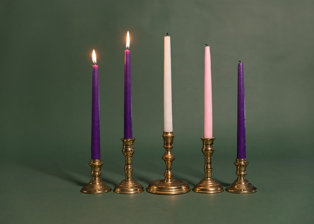 A group of four candles sitting next to each other