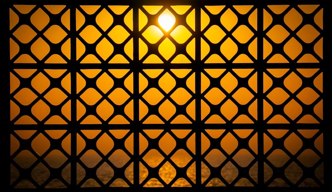 Sunlight shines through a patterned window.
