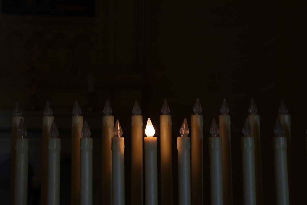 a group of lit candles sitting next to each other