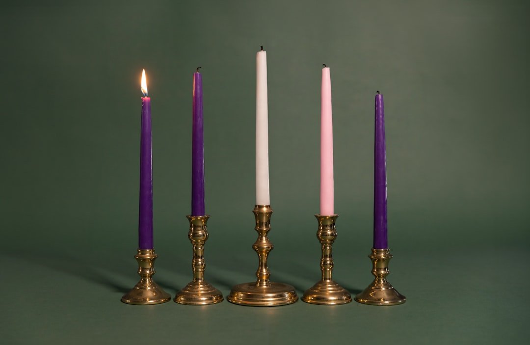 A group of four candles sitting next to each other
