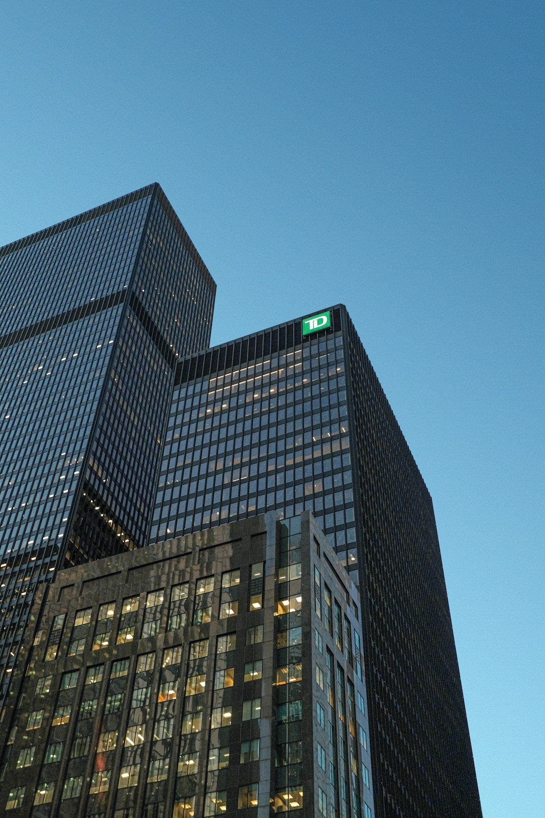 Modern skyscrapers against a clear blue sky.