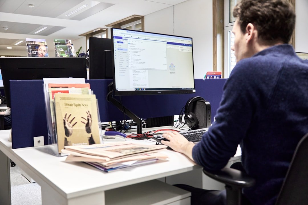 Man working at a computer in an office.