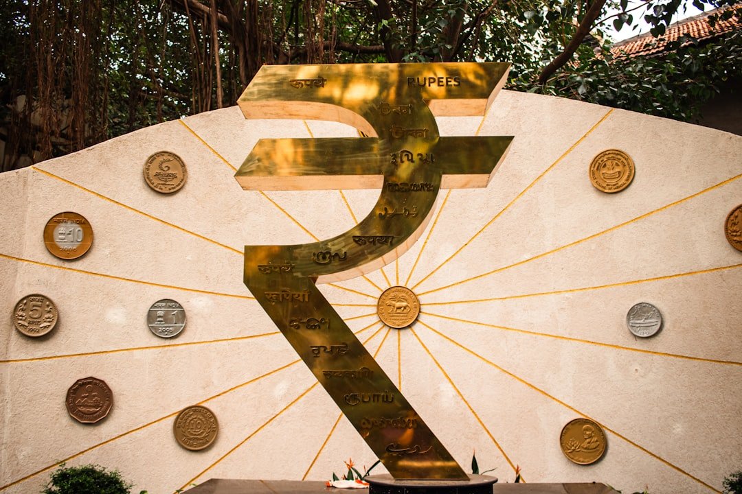 The image features a large indian rupee symbol.