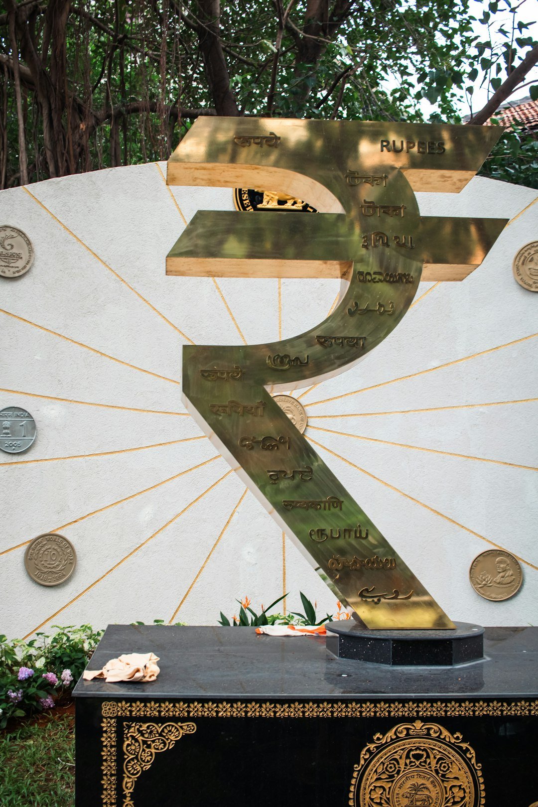 A monument displays the indian rupee symbol.