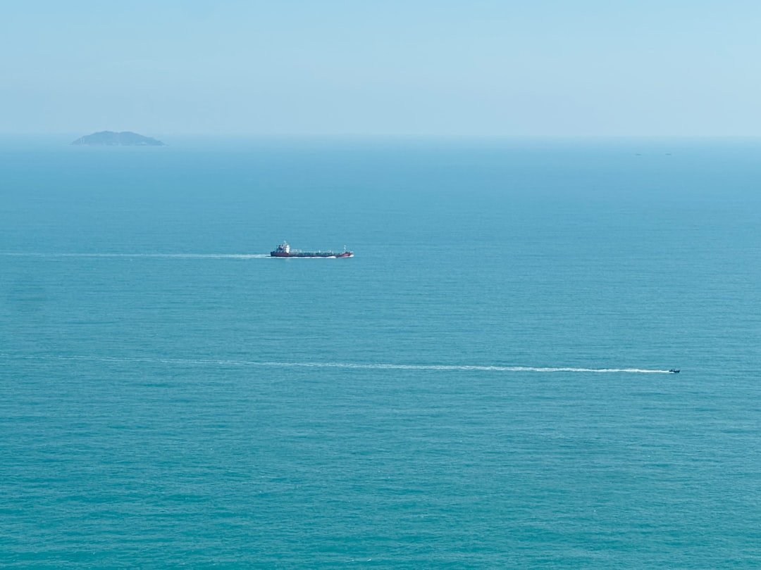Ship sailing on the vast blue ocean horizon