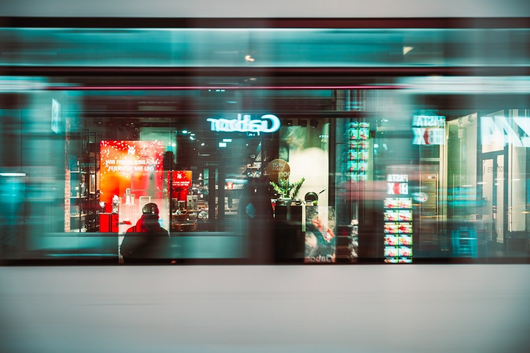 Blurry view of a storefront with neon lights