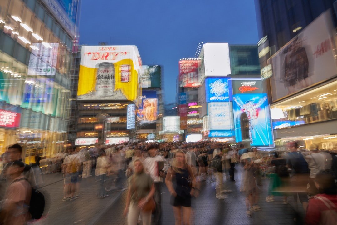 Crowded city street with bright neon signs at night