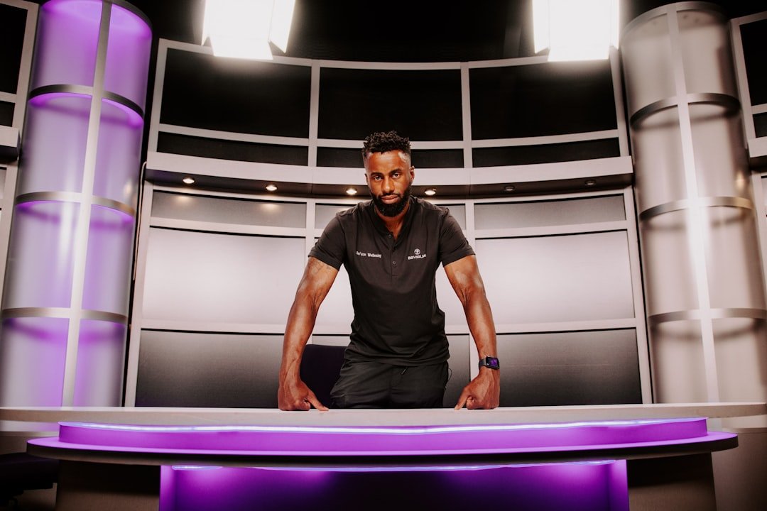 a man standing in front of a purple table