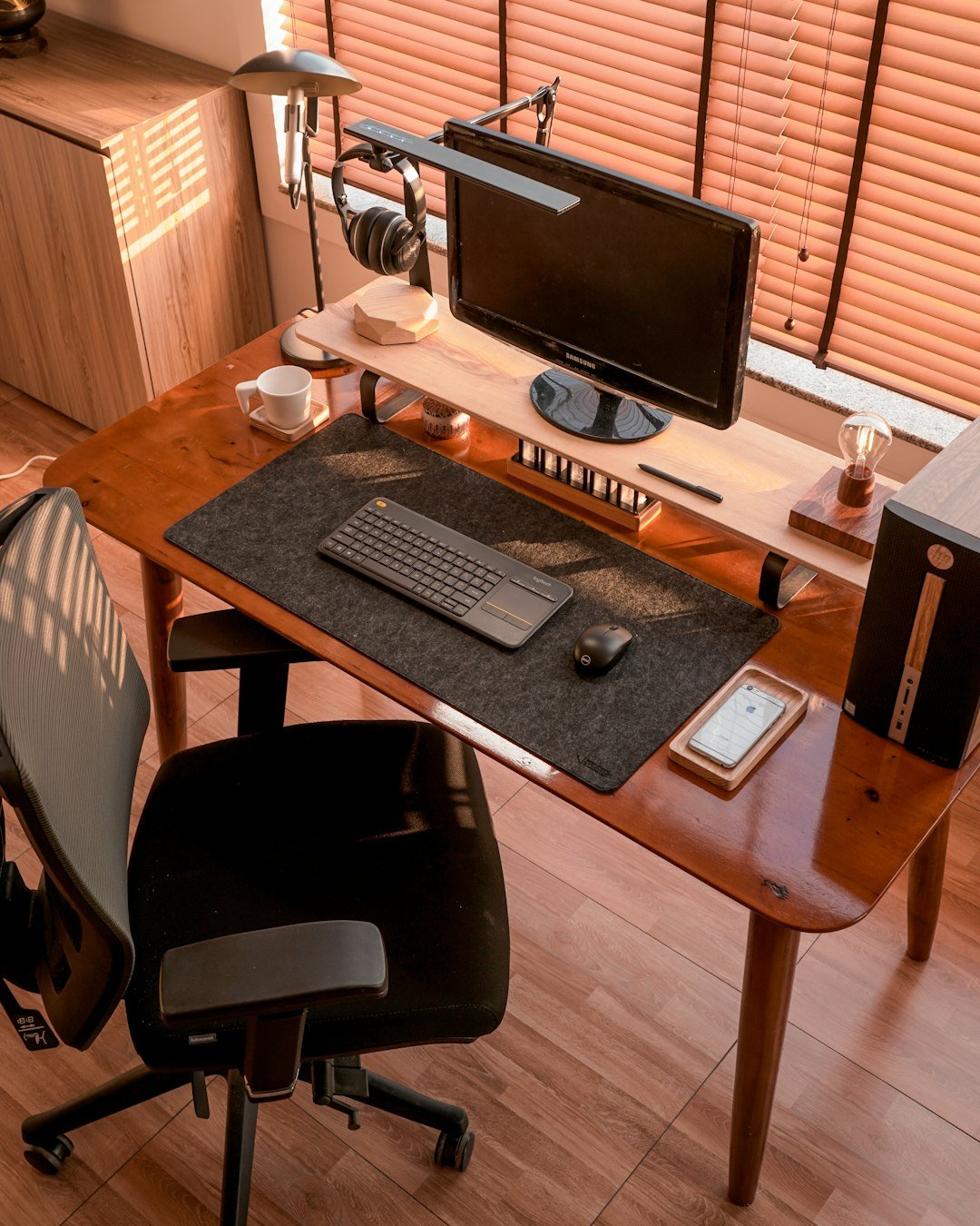 a computer desk with a monitor, keyboard and mouse