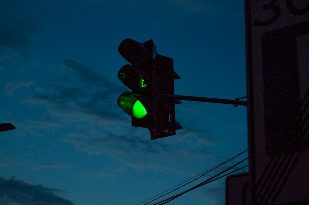 green traffic light under blue sky