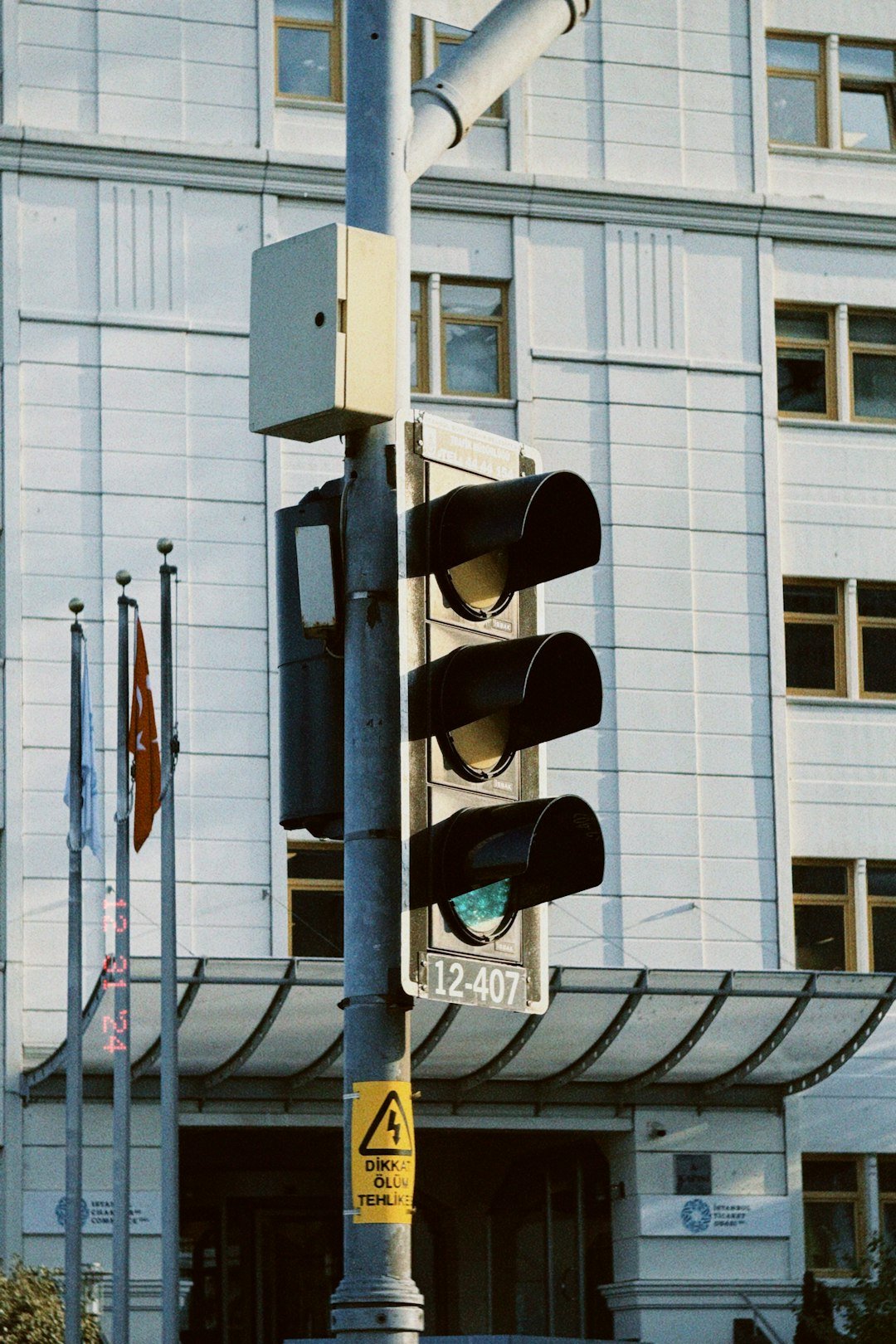 A traffic light sitting in front of a tall building