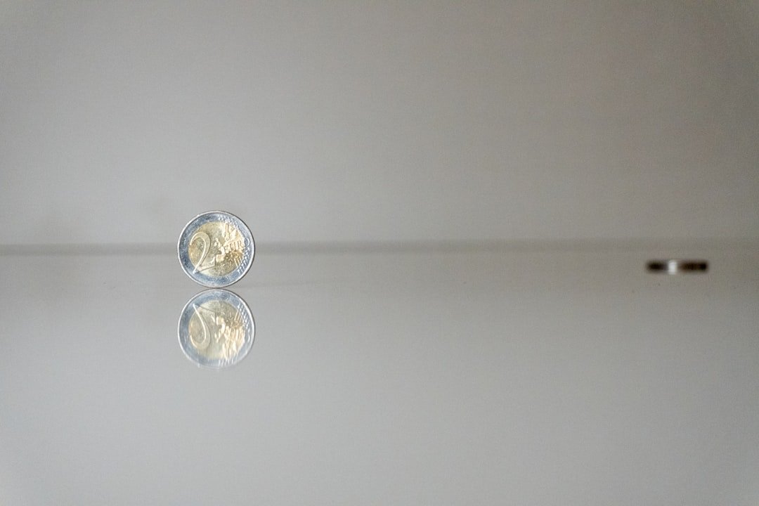 a white wall with a reflection of a light on it