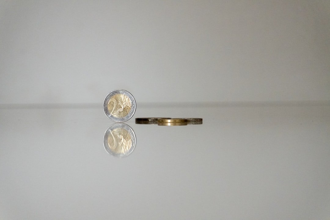 a gold ring with a coin on top of it